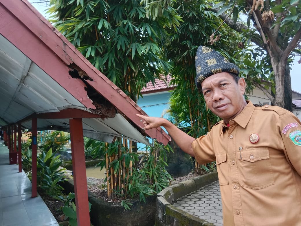 Kepala SMK Negeri 5 Palembang, Zulkarnain saat menunjukkan atap gedung SMKN 5 nyaris ambruk
